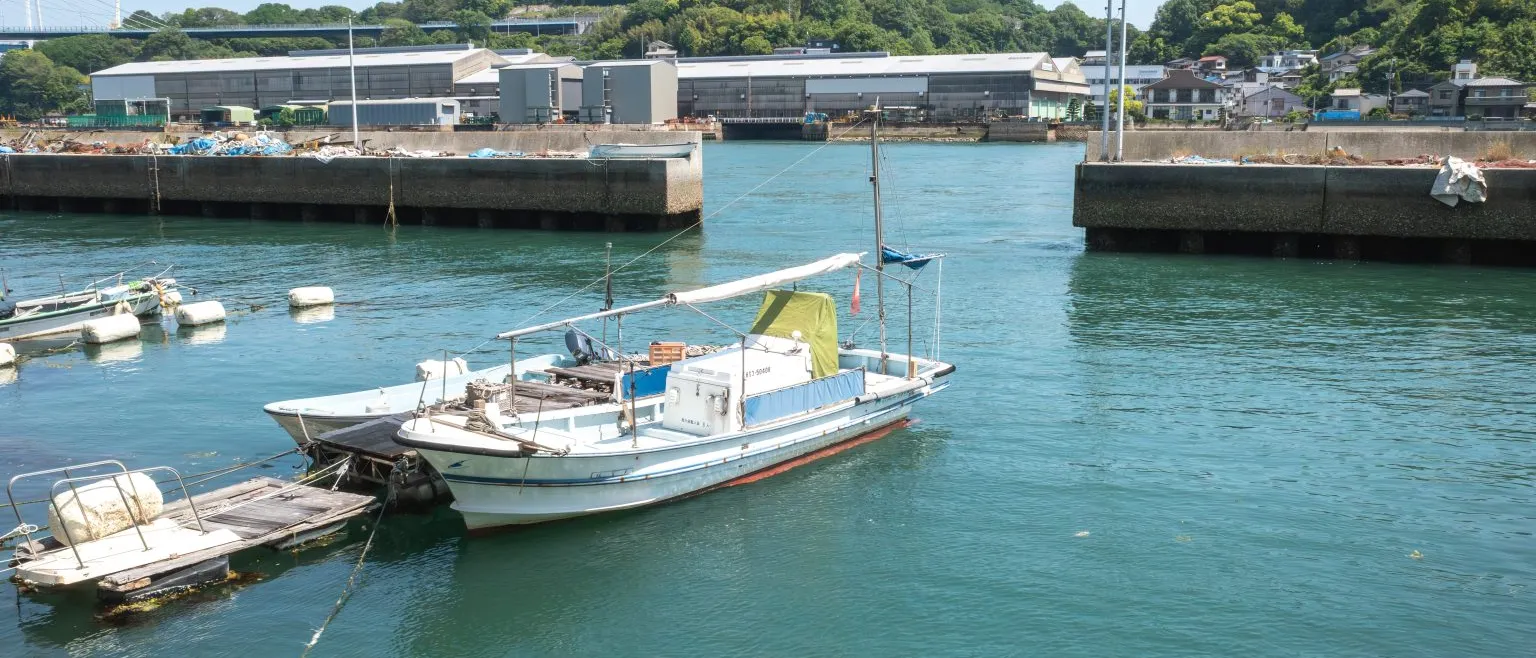 Boats moored along a channel in a small fishing town.